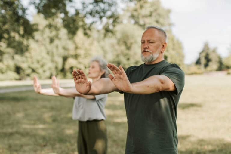 Older adults doing standing yoga poses in a park – Spry Living Pilates and Yoga for adults 55+