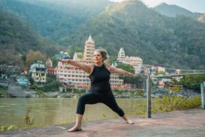 Older woman doing yoga outdoors by a river – Spry Living’s low-impact wellness blog for seniors